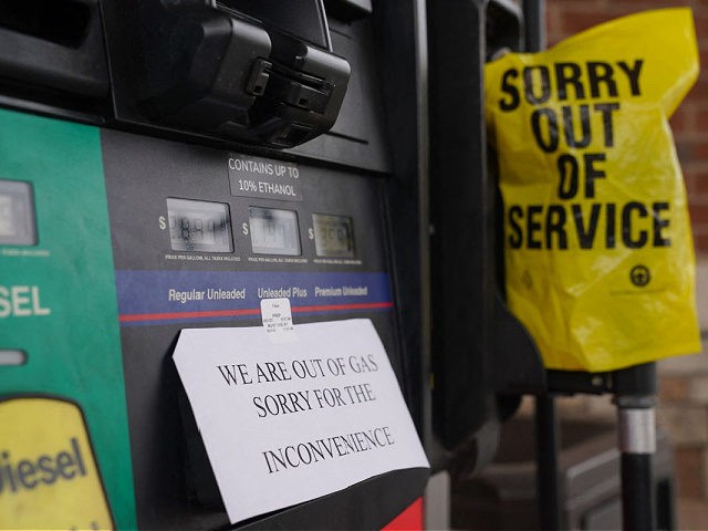A sign warns consumers on the avaliability of gasoline at a RaceTrac gas station on May 11, 2021, in Smyrna, Georgia. - Fears the shutdown of a major fuel pipeline would cause a gasoline shortage led to some panic buying and prompted US regulators on May 11, 2021 to temporarily …