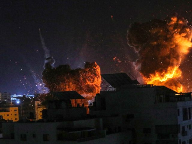 GAZA CITY, GAZA - MAY 18: Fire and smoke rise above buildings in Gaza City as Israeli warp