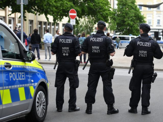 Policemen stand in front of the synagogue during a vigil of the Initiative against Anti-Se