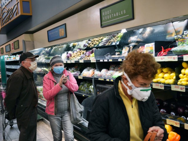 In this March 20, 2020, file photo, customers wear protective masks while shopping for groceries in the Sherman Oaks section of Los Angeles. Los Angeles Mayor Eric Garcetti has recommended that the city's 4 million people wear masks when going outside amid the spreading coronavirus. (AP Photo/Richard Vogel, File)