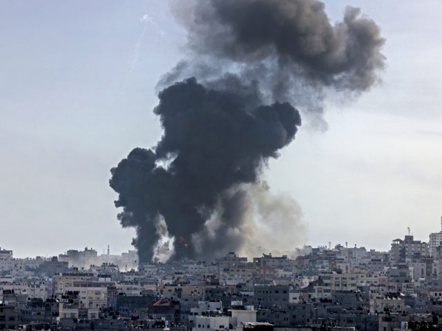 Smoke billows following an Israeli air strike on targets in Gaza City early on May 12, 2021 - Intense fighting between Palestinian militants and the Israeli army continued overnight, after Israeli Prime Minister warned Hamas that they will pay a "heavy price" for firing rockets from Gaza into Israel. (Photo …