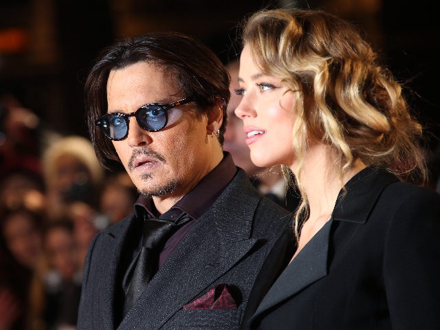 Actor Johnny Depp and Amber Heard pose for photographers upon arrival at the premiere of the film Mortdecai, in London, Monday, Jan. 19, 2015. (Photo by Joel Ryan/Invision/AP)