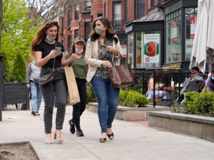 Pedestrians walk along Boston's fashionable Newbury Street, Sunday, May 2, 2021. In Massac