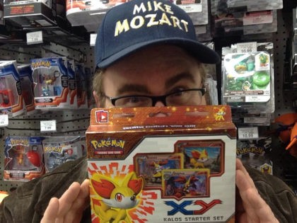 man holding pokemon cardsman holding pokemon cards