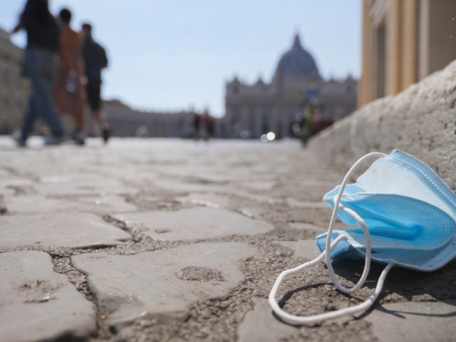 A protective mask is seen on the ground near St.Peter's Square, in Rome, Wednesday, Aug. 12, 2020. Italy produced 10% less garbage during its coronavirus lockdown, but environmentalists warn that increased reliance on disposable masks and packaging is imperiling efforts to curb single-use plastics that end up in oceans and seas. (AP Photo/Paolo Santalucia)