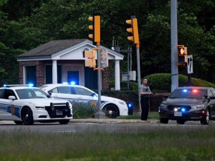 Police cars are seen outside the CIA headquarters's gate after an attempted intrusion earlier in the day in Langley, Virginia, on May 3, 2021. - An armed person was shot by FBI agents Monday after a standoff of several hours at the entry gate to the CIA headquarters, the federal …