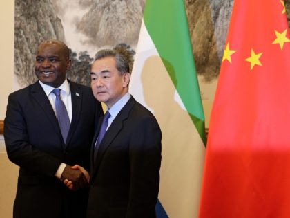 Sierra Leone's Foreign Minister Alie Kabba (L) and Chinese Foreign Minister Wang Yi shake hands before proceeding to their meeting at the Diaoyutai State Guesthouse in Beijing on January 11, 2019. (Photo by Andy Wong / POOL / AFP) (Photo credit should read ANDY WONG/AFP via Getty Images)