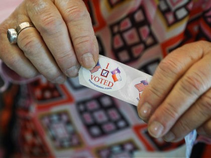 HOUSTON, TX - NOVEMBER 06: A woman hands out "I voted" stickers to voters at the Rummel Creek Elementary polling place on November 6, 2018 in Houston, Texas. Voters visited polling places around Texas on Election Day to cast their ballots in the midterms. (Photo by Loren Elliott/Getty Images)