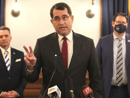 Kansas Attorney General Derek Schmidt discusses a proposal that he's pushing with other Republicans to amend the state constitution to give the Legislature the power to overturn state agencies' administrative regulations, at a news conference, Tuesday, Feb. 23, 2021, at the Statehouse in Topeka, Kan. Behind him are Senate President …