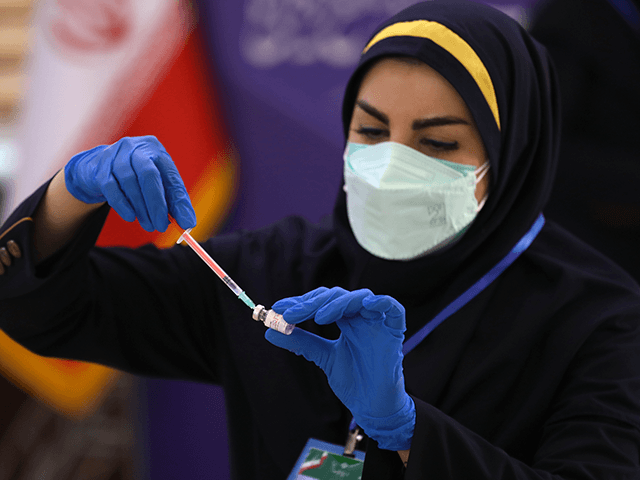 Medic Azin Chakeri prepares a Coviran Barekat Covid-19 vaccine to administer to volunteers