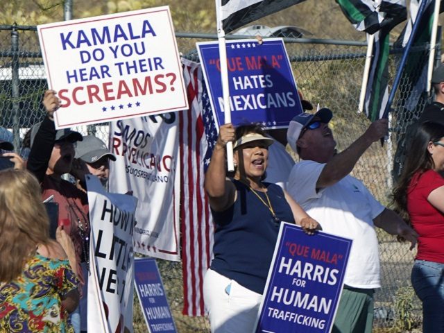 As Vice President Kamala Harris arrives to tour the U.S. Customs and Border Protection Central Processing Center, Friday, June 25, 2021, in El Paso, Texas, people rally outside the facility. (AP Photo/Jacquelyn Martin)
