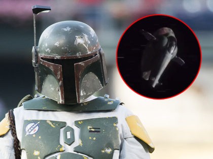 (INSET: Screenshot of the "Slave I" ship in Disney+ series "The Mandalorian") Star Wars Boba Fett looks on prior to the first inning of a baseball game between the Miami Marlins and the Philadelphia Phillies, Thursday, July 21, 2016, in Philadelphia. The Marlins won 9-3. (AP Photo/Chris Szagola)