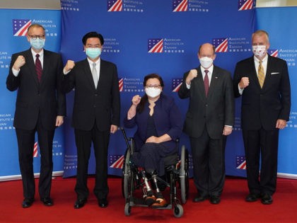 A delegation comprised of Senators Tammy Duckworth (C), Christoper Coons (2nd R) and Dan Sullivan (R) pose for photographs with Taiwans Foreign Minister Joseph Wu (2nd L) and American Institute in Taiwan (AIT) Director Brent Christensen (L) following their arrival at the Songshan Airport in Taipei on June 6, 2021. …
