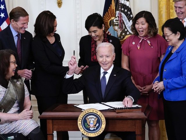 President Joe Biden hands out a pen after signing the COVID-19 Hate Crimes Act, in the East Room of the White House, Thursday, May 20, 2021, in Washington. Clockwise from left, Sen. Tammy Duckworth, R-Ill., Sen. Richard Blumenthal, D-Conn., Vice President Kamala Harris, Rep. Judy Chu, D-Calif., Rep. Grace Meng, …