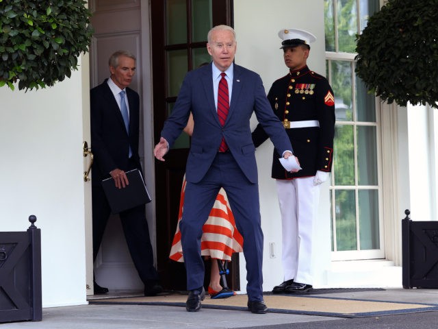 WASHINGTON, DC - JUNE 24: President Joe Biden reacts as he walks out to speak to journalist joined by a group of bipartisan Senators after the group of Senators reached a deal on an infrastructure package at the White House on June 24, 2021 in Washington, DC. Biden said both …