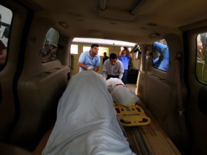 The bodies of El Salvadoran migrant Oscar Alberto Martinez Ramírez, 25, and his nearly two-year-old daughter Valeria, are placed into a funeral home van at the morgue in Matamoros, Tamaulipas state, Mexico, Wednesday, June 26, 2019. The pair drowned while trying to cross the Rio Grande to Brownsville, Texas. Martinez's …