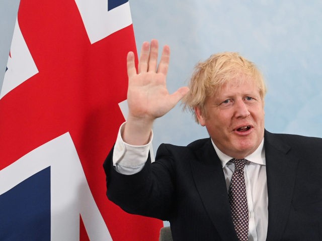 CARBIS BAY, ENGLAND - JUNE 10: Britain's Prime Minister Boris Johnson waves during a meeting with U.S. President Joe Biden (not pictured) ahead of the G7 summit, at the Carbis Bay Hotel, on June 10, 2021 near St Ives, England. UK Prime Minister, Boris Johnson, will host leaders from the …