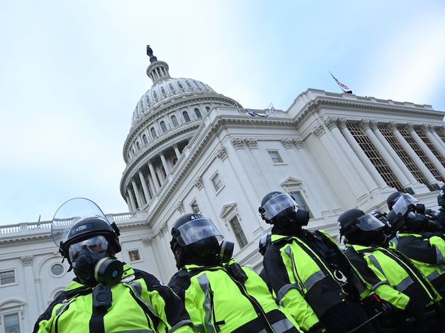 Police stand as supporters of US President Donald Trump protest outside the US Capitol on January 6, 2021, in Washington, DC. - Demonstrators breeched security and entered the Capitol as Congress debated the a 2020 presidential election Electoral Vote Certification. (Photo by Brendan SMIALOWSKI / AFP) (Photo by BRENDAN SMIALOWSKI/AFP via Getty Images)