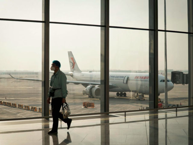 An airport worker walks along Daxing Airport in Beijing on February 8, 2021, ahead of Luna