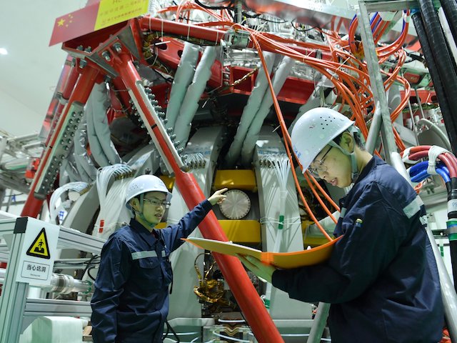 Technical personnel checks the Chinas HL-2M nuclear fusion device, known as the new generation of "artificial sun", at a research laboratory in Chengdu, in eastern China's Sichuan province on December 4, 2020. - China successfully powered its "artificial sun" nuclear fusion reactor for the first time, state media reported on December 4, marking a great advance in the country's nuclear power research capabilities. (Photo by STR / AFP) / China OUT (Photo by STR/AFP via Getty Images)