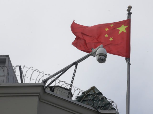 The flag of China flies behind a security camera over the Chinese Consulate in San Francisco, Thursday, July 23, 2020. The Chinese consulate in San Francisco is harboring a Chinese researcher who the FBI says lied about her military background. (AP Photo/Jeff Chiu)