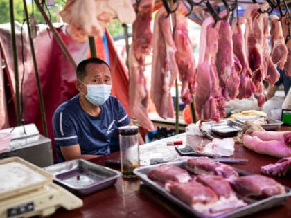 A vendor sells pork at an open market on May 31, 2021 in Wuhan, China. A renewed interest