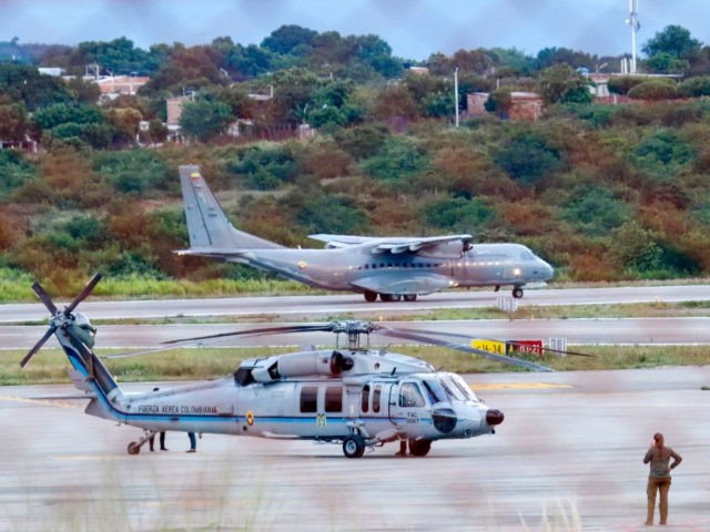 The Colombian presidential helicopter (L) sits at the tarmac of the Camilo Daza Internatio