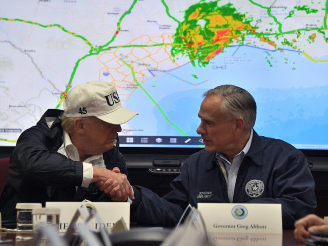 President Donald Trump shakes hands with Texas Governor Greg Abbott at the Texas Department of Public Safety Emergency Operations Center in Austin, Texas on August 29, 2017, as rains from Hurricane Harvey continue to flood parts of Texas. US President Donald Trump flew into storm-ravaged Texas Tuesday in a show …