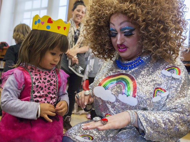 In this Saturday, May 13, 2017 photo, Lil Miss Hot Mess, right, compares outfits with 2-year old Eva McInnes after reading to a group of children during the Feminist Press' presentation of Drag Queen Story Hour! at the Park Slope Branch of the Brooklyn Public Library, in New York. (AP …