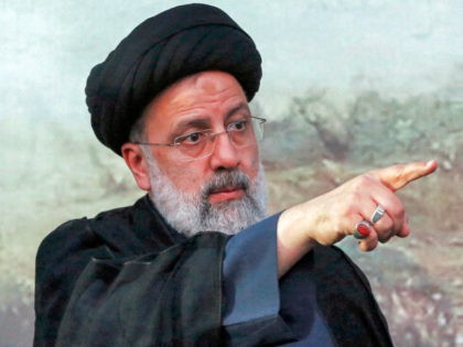 Iranian presidential candidate Ebrahim Raisi gestures during an election campaign rally in