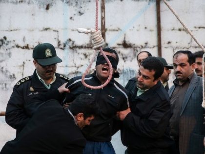 Balal, who killed Iranian youth Abdolah Hosseinzadeh in a street fight with a knife in 2007, is brought to the gallows during his execution ceremony in the northern city of Noor on April 15, 2014. The mother of Abdolah Hosseinzadeh spared the life of the her son's convicted murderer, with …