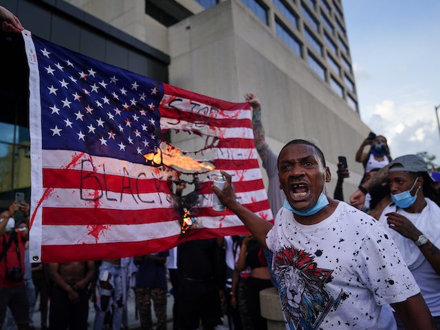 People protest the Minneapolis death of George Floyd while in police custody outside CNN Center on May 29, 2020 in Atlanta, Georgia. (Photo by Elijah Nouvelage/Getty Images)