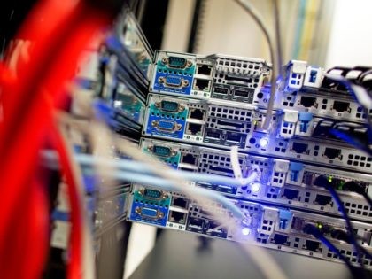 Cables link servers in carefully controlled environments inside Servecentric Data Centre on the outskirts of Dublin in Ireland on December 10, 2018. - Fortunes are being made in clusters of anonymous warehouses outside Dublin that contain vast data centres driving the digital boom of a fourth industrial revolution. (Photo by …