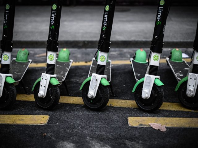 This picture taken on June 12, 2019 shows Lime-S electric scooters of US transportation company Lime parked in a street of Paris. (Photo by Philippe LOPEZ / AFP) (Photo credit should read PHILIPPE LOPEZ/AFP via Getty Images)