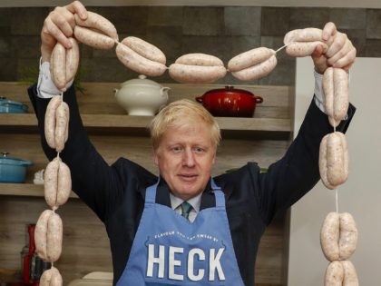 Conservative MP and leadership contender Boris Johnson poses with a string of sausages called "Boris Bangers" during a visit to Heck Foods near Bedale, northwest England on July 4, 2019. - Britain's leadership contest is taking the two contenders on a month-long nationwide tour where they will each attempt to …