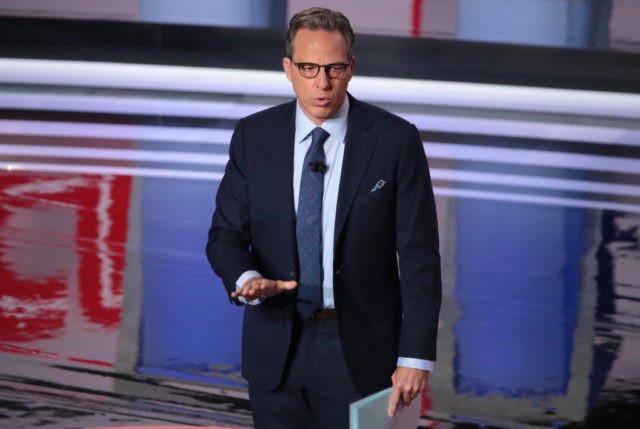 DETROIT, MICHIGAN - JULY 31: CNN moderator Jake Tapper speaks to the crowd attending the Democratic Presidential Debate at the Fox Theatre July 31, 2019 in Detroit, Michigan. 20 Democratic presidential candidates were split into two groups of 10 to take part in the debate sponsored by CNN held over …