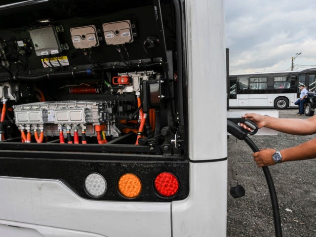 A man charges a new imported electric bus in Medellin, Colombia, on September 17, 2019. - A new fleet of 64 electric buses is the second largest in a Latin America city and will start operating in November, according to local authorities. (Photo by JOAQUIN SARMIENTO / AFP) (Photo credit …