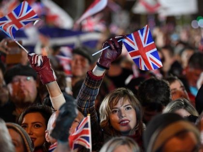 TOPSHOT - Brexit supporters wave Union flags as the time nears 11 O'Clock, in Parliament Square, venue for the Leave Means Leave Brexit Celebration in central London on January 31, 2020, the moment that the UK formally leaves the European Union. - Brexit supporters gathered outside parliament on Friday to …