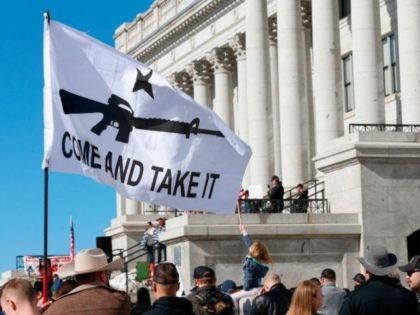 People gather in protest to new gun legislation at the Utah State Capitol in Salt Lake City, Utah on February 8, 2020. - The protestors are opposing new gun legislation that they say will restrict their US second amendment rights. Utah is an open carry state. (Photo by GEORGE FREY …
