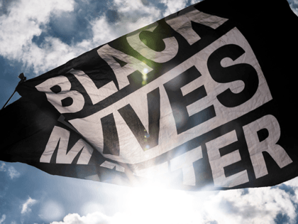 A Black Lives Matter flag waves during a demonstration outside the First Police Precinct Station on June 13, 2020 in Minneapolis, Minnesota. Protests and demonstrations have continued in cities around the world in the wake of George Floyd's death in Minneapolis Police custody on May 25. (Photo by Stephen Maturen/Getty …