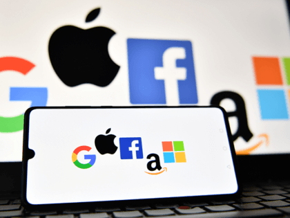 An illustration picture taken in London on December 18, 2020 shows the logos of Google, Apple, Facebook, Amazon and Microsoft displayed on a mobile phone and a laptop screen. (Photo by JUSTIN TALLIS / AFP) (Photo by JUSTIN TALLIS/AFP via Getty Images)