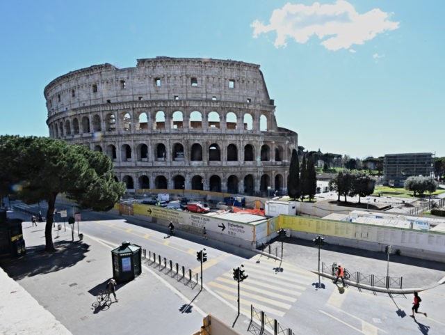 TOPSHOT - Streets are almost emty in front of the Ancient Colosseum in central Rome, on Ma