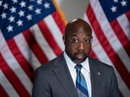 WASHINGTON, DC - APRIL 20: Sen. Raphael Warnock (D-GA) (L) speaks during a news conference following the weekly Democrat policy luncheon on Capitol Hill on April 20, 2021 in Washington, DC. The Democratic Senators spoke about the COVID-19 Hate Crimes Act. (Photo by Sarah Silbiger/Getty Images)