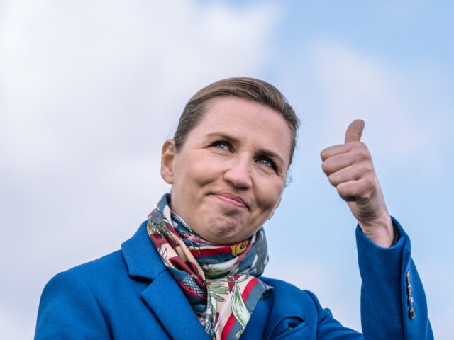 Denmark's Prime Minister Mette Frederiksen reacts with a thumb up as she stands on a