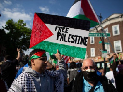 TOPSHOT - A man holds a "Free Palestine" sign during a demonstration in support of Palesti