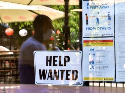 A 'Help Wanted' sign is posted beside Coronavirus safety guidelines in front of a restaurant in Los Angeles, California on May 28, 2021. - Following over a year of restrictions due to the coronavirus pandemic, many jobs at restaurants, retail stores and bars remain unfilled, despite California's high unemployment rate, …