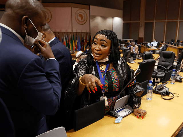 Pan African Parliament member Maria Traore speaks to another inside the house following its postponement in Midrand, Johannesburg on June 1, 2021. - The house was adjourned following chaotic and violent scenes that played out during the leadership rotation elections. (Photo by Phill Magakoe / AFP) (Photo by PHILL MAGAKOE/AFP …