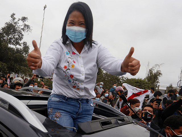 Peruvian presidential candidate, right-wing Keiko Fujimori, greets her supporters as she leaves the polling station after casting her vote, during the presidential runoff election in Lima, on June 6, 2021. - Peruvians face a polarising choice between right-wing populist Keiko Fujimori and radical leftist Pedro Castillo when they elect a …