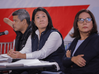 Peruvian right-wing presidential candidate for Fuerza Popular, Keiko Fujimori (C), flanked