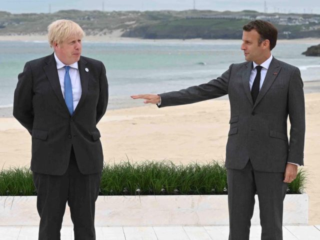Britain's Prime Minister Boris Johnson poses with France's President Emmanuel Macron (R) at the start of the G7 summit in Carbis Bay, Cornwall, south-west England on June 11, 2021. - G7 leaders from Canada, France, Germany, Italy, Japan, the UK and the United States meet this weekend for the first …